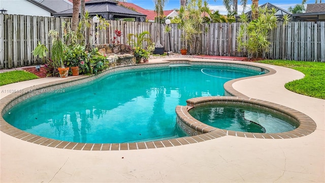 view of swimming pool with an in ground hot tub and a patio area