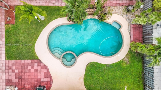 view of pool with a lawn