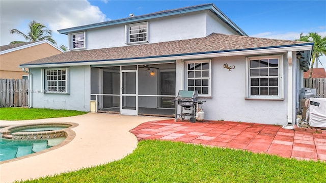 back of property featuring an in ground hot tub, a patio, and ceiling fan