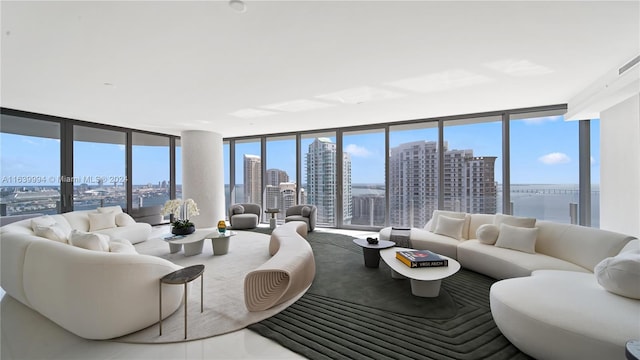 living room featuring a water view, plenty of natural light, and expansive windows