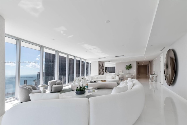 living room featuring floor to ceiling windows and a water view