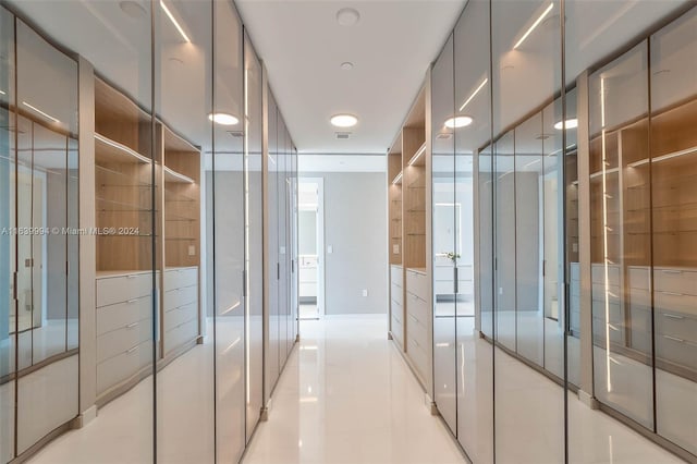 walk in closet featuring light tile patterned flooring