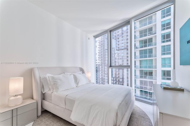 carpeted bedroom featuring expansive windows