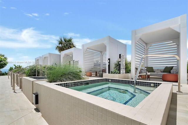 view of swimming pool with an in ground hot tub