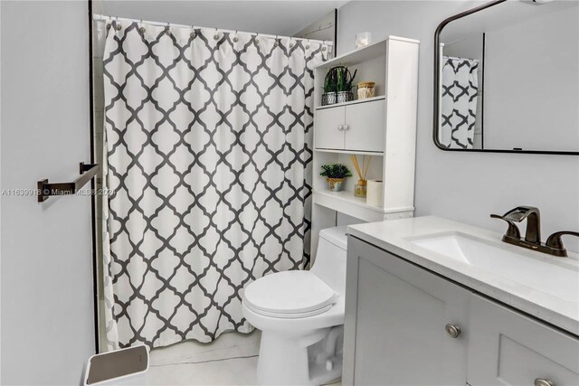 bathroom with tile patterned floors, vanity, and toilet