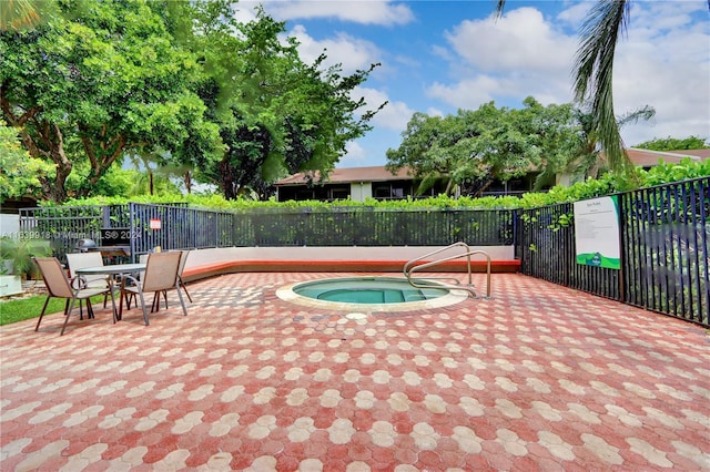 view of swimming pool featuring a patio and a hot tub