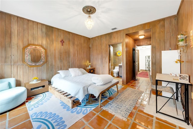 16255 SW 216th St, Miami, FL 33170 - bedroom with wood walls, a chandelier, light tile patterned flooring, and connected bathroom