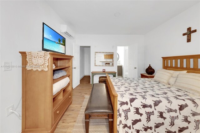 16255 SW 216th St, Miami, FL 33170 - bedroom featuring light wood finished floors, a wall mounted AC, and connected bathroom