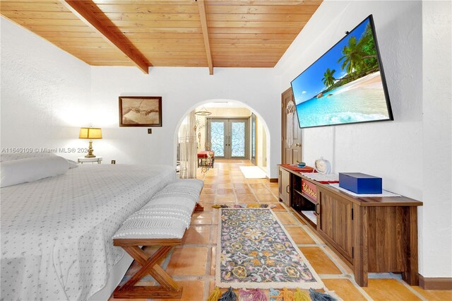 16255 SW 216th St, Miami, FL 33170 - bedroom featuring arched walkways, wood ceiling with exposed beams, french doors, and stone tile floors