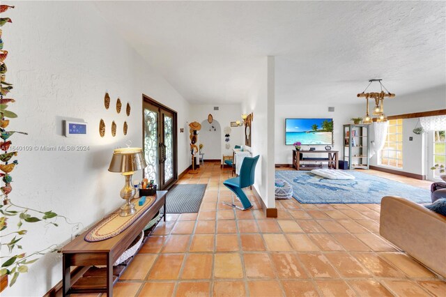 16255 SW 216th St, Miami, FL 33170 - living room featuring baseboards, light tile patterned floors, and a textured ceiling