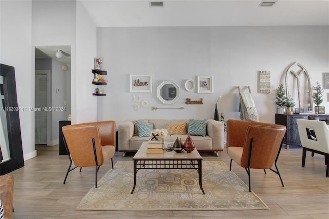 living area with light wood-style flooring and baseboards