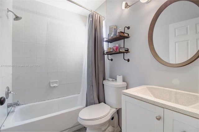 full bath featuring toilet, shower / bath combo with shower curtain, and vanity