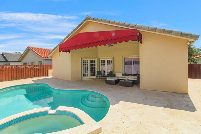 view of swimming pool featuring an in ground hot tub, a patio, and french doors