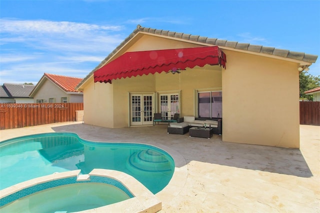 rear view of house with a patio area, outdoor lounge area, a fenced backyard, and stucco siding