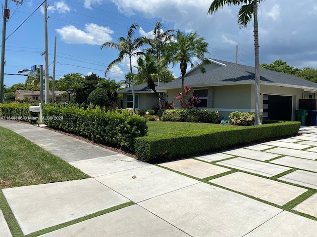 exterior space with a front yard and a garage