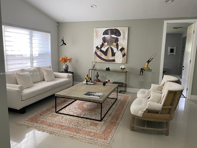 living room featuring tile patterned floors and vaulted ceiling