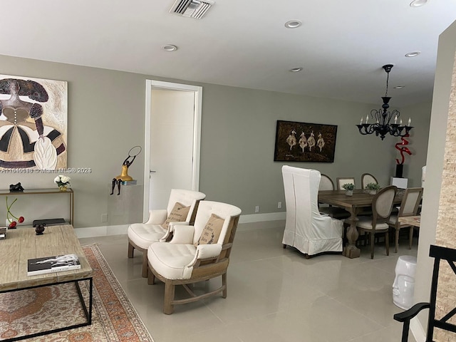 tiled living room featuring an inviting chandelier