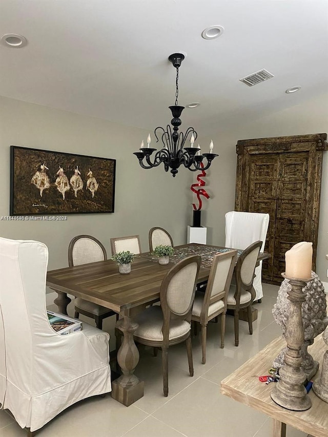 tiled dining area with an inviting chandelier