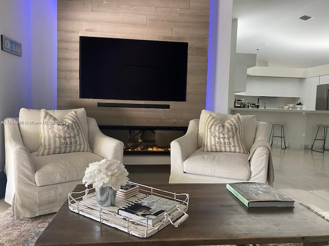 living room with wood walls and tile patterned flooring