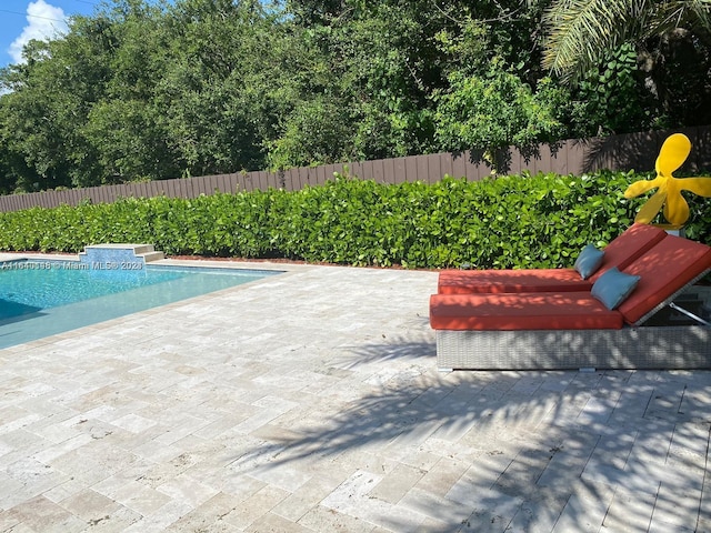 view of swimming pool with a patio