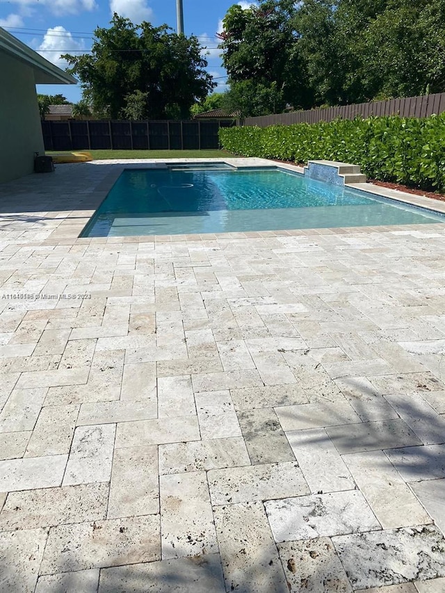 view of swimming pool with a patio