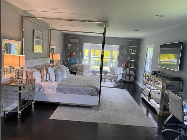 bedroom with dark hardwood / wood-style flooring