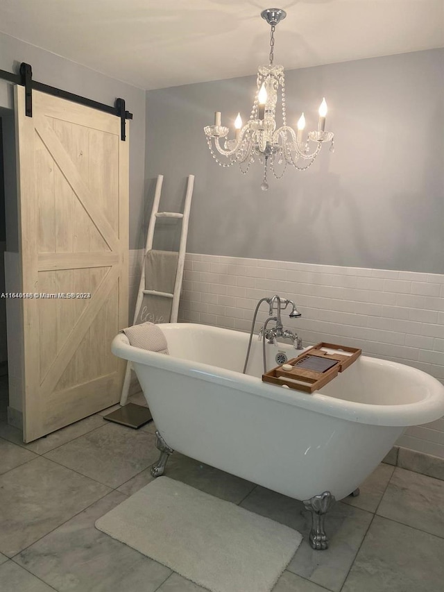 bathroom with a notable chandelier, tile walls, a tub, and tile patterned flooring