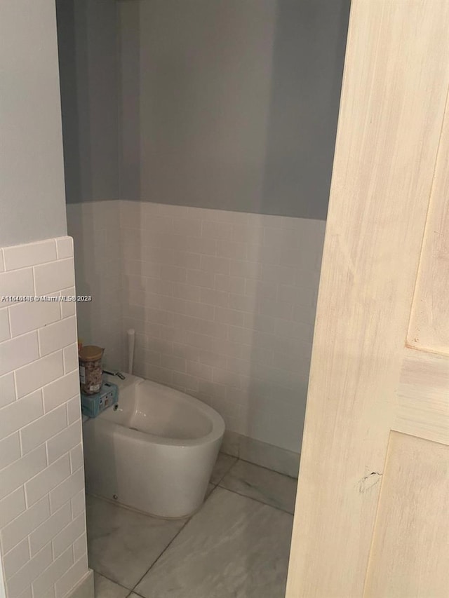 bathroom featuring tile walls and tile patterned flooring