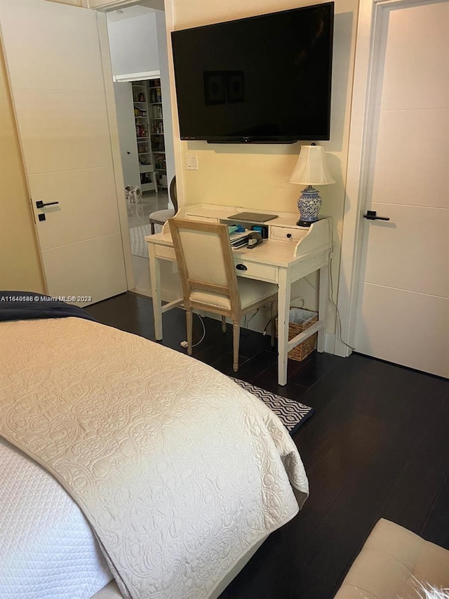 bedroom with dark wood-type flooring