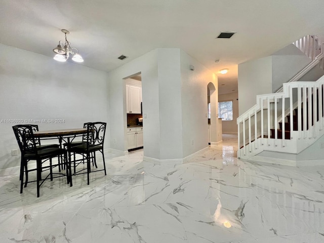 dining space featuring a notable chandelier