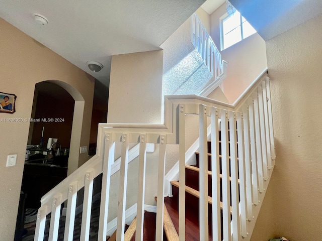 stairs featuring hardwood / wood-style floors