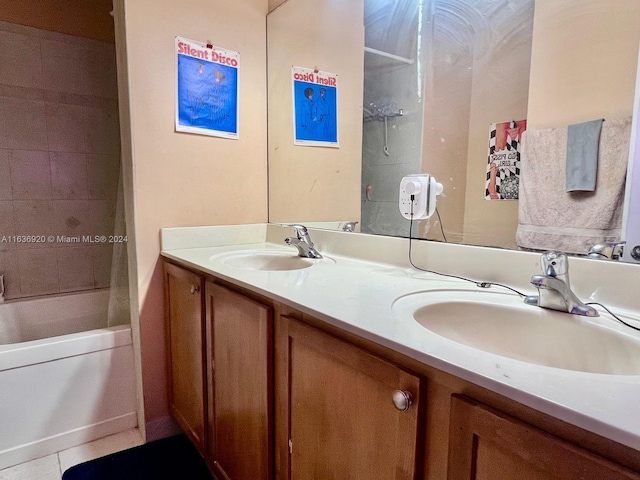 bathroom featuring tile patterned flooring, vanity, and tiled shower / bath combo