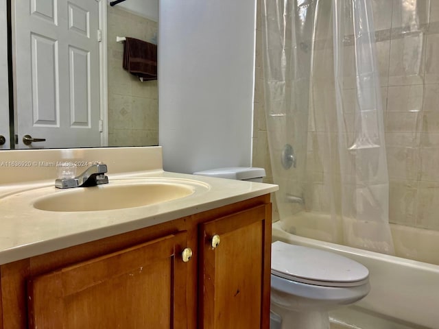 full bathroom featuring shower / bath combo, vanity, and toilet