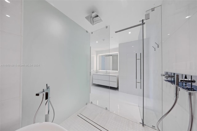 bathroom featuring tile patterned floors, vanity, and walk in shower