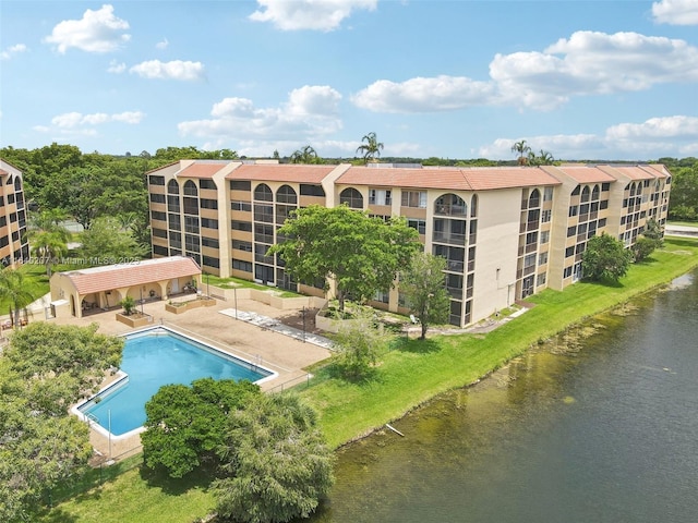 view of pool featuring a patio and a water view