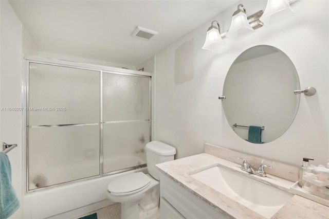 full bathroom with vanity, toilet, and shower / bath combination with glass door