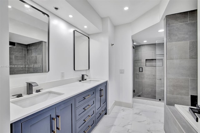 bathroom featuring a shower with door and vanity