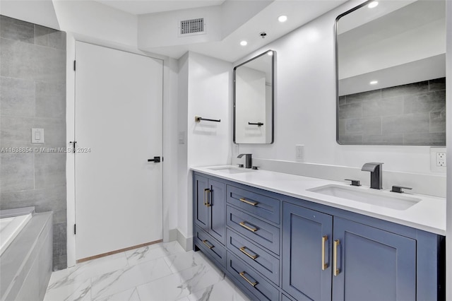 bathroom featuring vanity and a bath