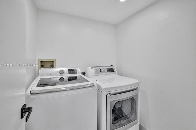 clothes washing area with independent washer and dryer