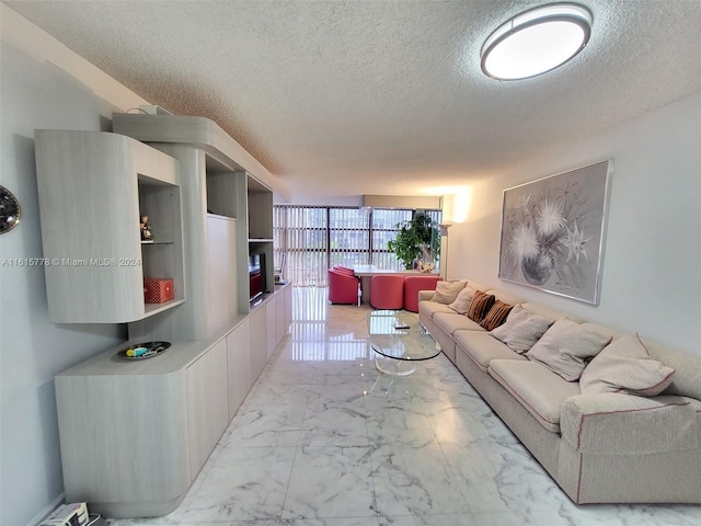 living room with light tile patterned flooring and a textured ceiling