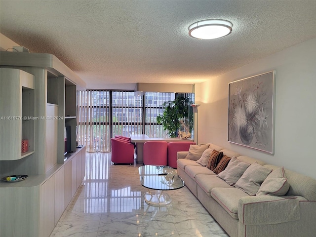 living room featuring a wall of windows, a textured ceiling, and light tile patterned floors