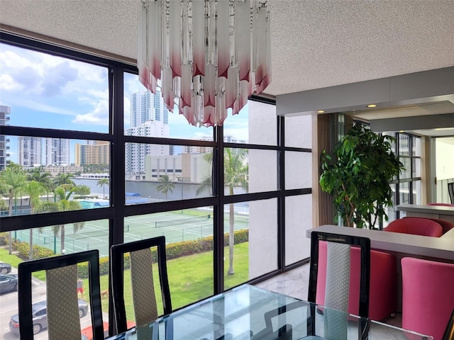 interior space featuring tile patterned floors, a textured ceiling, and expansive windows