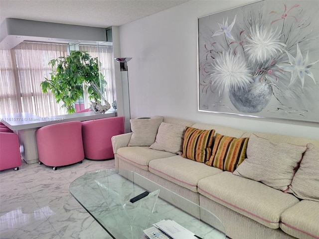 tiled living room featuring a textured ceiling