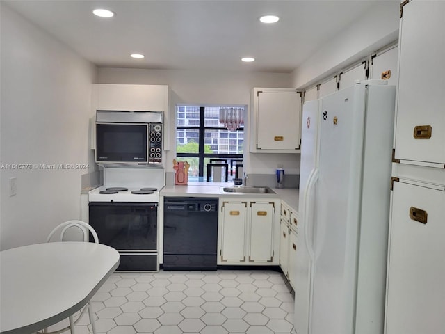 kitchen featuring black appliances, white cabinetry, sink, and light tile patterned floors