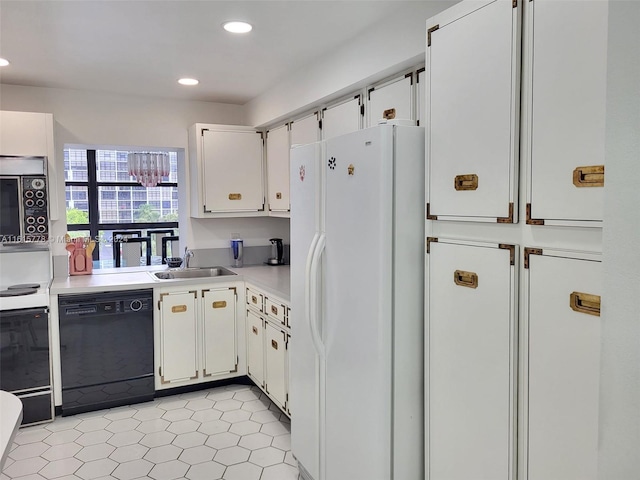 kitchen with light tile patterned floors, white cabinets, white appliances, and sink