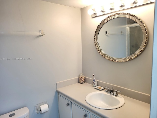 bathroom featuring vanity and toilet