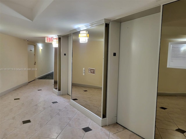 hall with light tile patterned floors