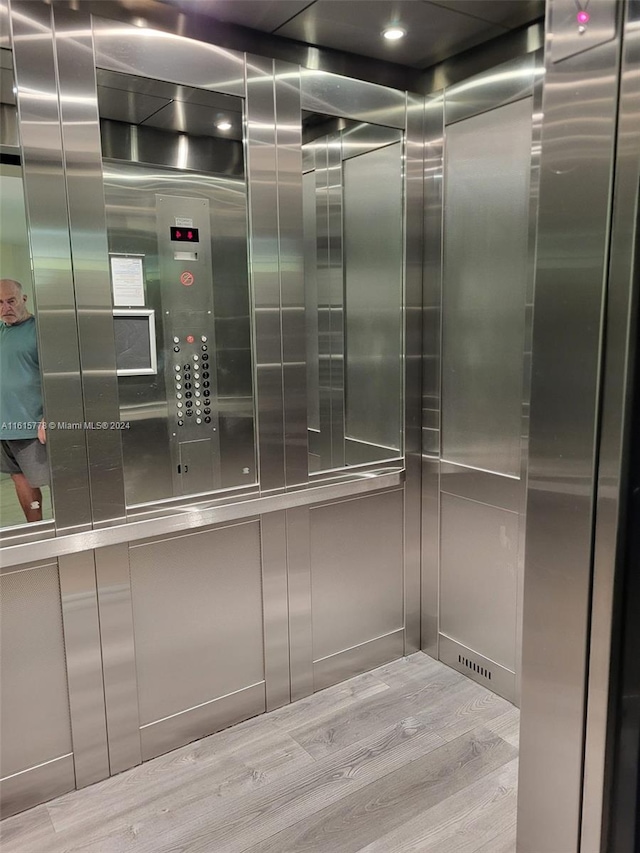 room details featuring wood-type flooring and elevator