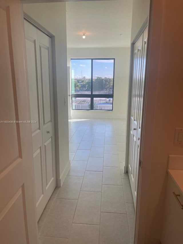 hallway featuring light tile patterned floors