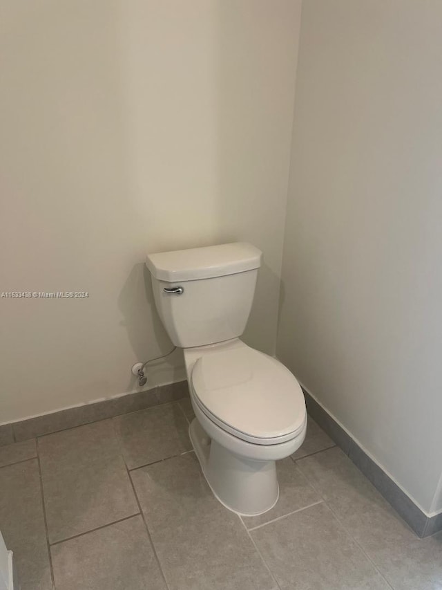 bathroom featuring toilet and tile patterned floors